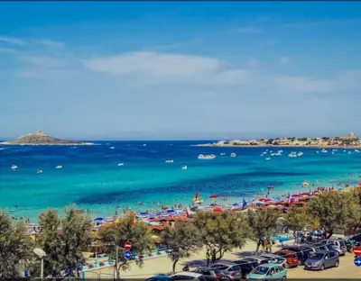 a beach with a lot of people and the ocean at Pietra Marina in Capaci