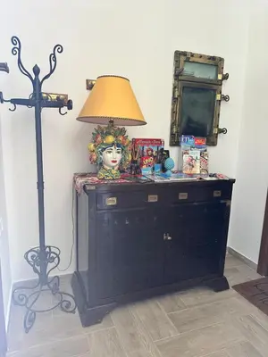 a room with a dresser with a lamp and a mirror at Addaura Luxury Apartment in Palermo