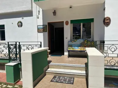 a house with a porch with a couch in the doorway at Addaura Luxury Apartment in Palermo
