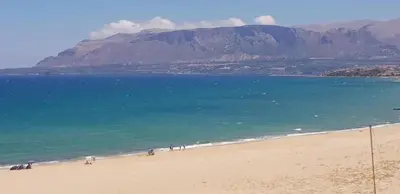 a view of a beach with a mountain in the background at Spacious Apartment in Balestrate 70 m² with Balcony in Balestrate