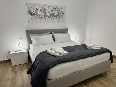 a bedroom with a large bed with two towels on it at Mortillaro 19 in Palermo