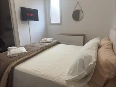 a white bed with two towels on top of it at Mortillaro 19 in Palermo
