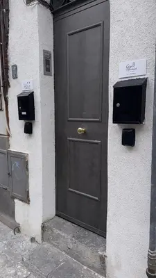a black door on the side of a building at Gigi's Apartment in Palermo