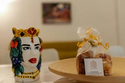 a table with two bags of bread and a vase at Palermo Home Politeama in Palermo