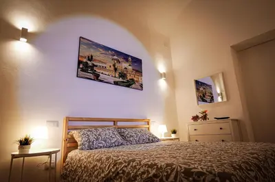 a bedroom with a bed and two pictures on the wall at Palermo Home Politeama in Palermo
