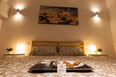 a tray of food on top of a bed at Palermo Home Politeama in Palermo