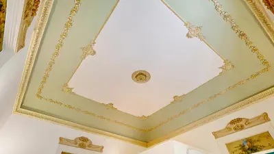 a coffered ceiling with a ceiling light in a room at Palazzo Genuardi - charming rooms - in Palermo