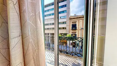 a view of a city street from a window at Palazzo Genuardi - charming rooms - in Palermo