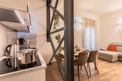 a kitchen and dining room with a table in a room at Politeama Luxury Suite in Palermo