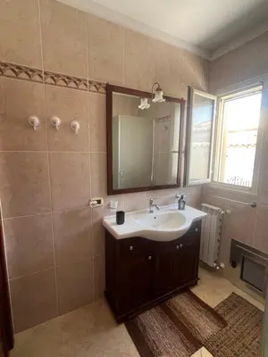 a bathroom with a sink and a mirror at Carini house in Carini