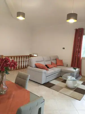 a living room with a couch and a table at Carini house in Carini