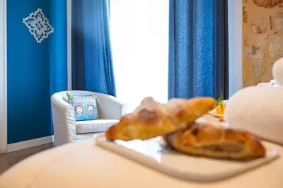 two croissants sitting on a table in a room at Palazzo Carella in Palermo