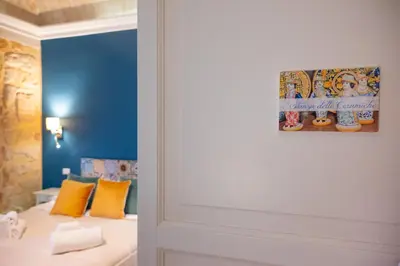 a room with a bed and a painting on the wall at Palazzo Carella in Palermo