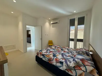 a bedroom with a bed with a colorful comforter at Politeama Libertà Home Sweet Home in Palermo