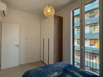 a bedroom with a bed and a large window at Politeama Libertà Home Sweet Home in Palermo