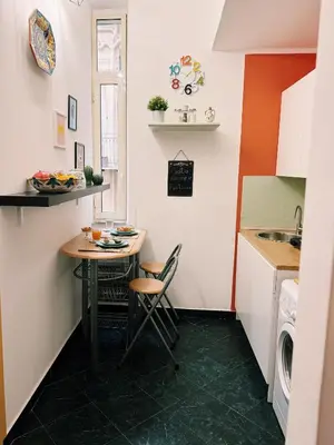 a small kitchen with a table and a sink at Quattru Passi in Palermo