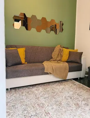a couch sitting in a living room with a wall at Quattru Passi in Palermo