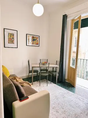 a living room with a couch and a table at Quattru Passi in Palermo