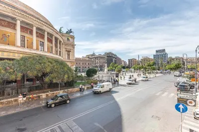 a city street with cars parked on the street at Turati Apartment al Politeama by Wonderful Italy in Palermo