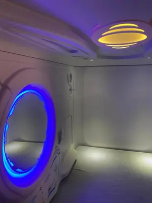 a room with a blue light and a mirror at Mermaid Space Capsule Hostel Palermo in Palermo