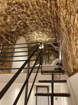a staircase in a cave with a stone wall at Appartamento Centro Storico in Palermo
