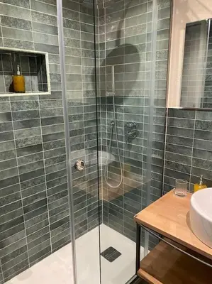 a shower with a glass door in a bathroom at Appartamento Centro Storico in Palermo