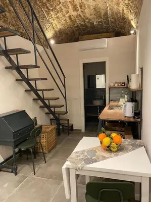 a kitchen with a staircase and a table with fruit on it at Appartamento Centro Storico in Palermo