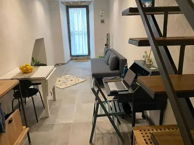 a living room with a table with a laptop on it at Appartamento Centro Storico in Palermo