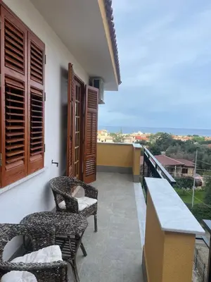 a balcony of a house with chairs and a table at Casa MaRo' in Capaci