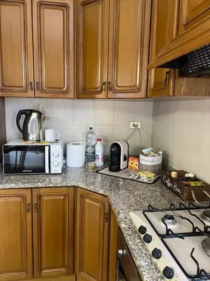 a kitchen counter top with a microwave and a stove at Casa MaRo' in Capaci