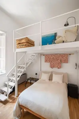 a bedroom with a bunk bed and a staircase at Libertà Appartement in Palermo