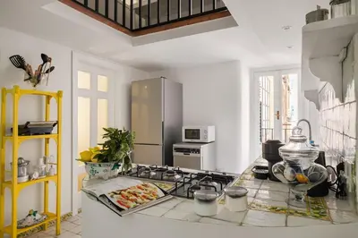 a kitchen with a counter with a stove top oven at Libertà Appartement in Palermo