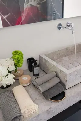 a bathroom with a sink with towels on a counter at Libertà Appartement in Palermo