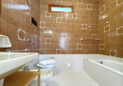 a bathroom with a toilet and a tub and a sink at Solemar Sicilia - Ville Paradiso in Santa Flavia