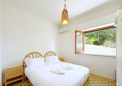 a bedroom with two beds and a window at Solemar Sicilia - Ville Paradiso in Santa Flavia