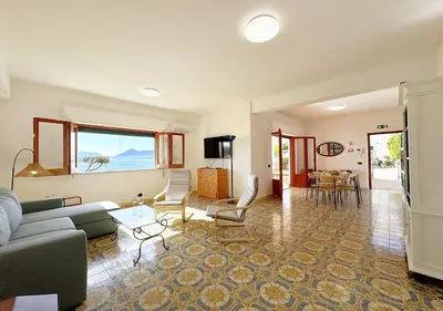 a living room with a couch and a table at Solemar Sicilia - Ville Paradiso in Santa Flavia