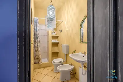 a bathroom with a toilet and a sink at Verosicily Panoramic House with access to the sea in Terrasini