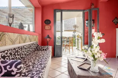 a living room with a couch and a table at Verosicily Panoramic House with access to the sea in Terrasini