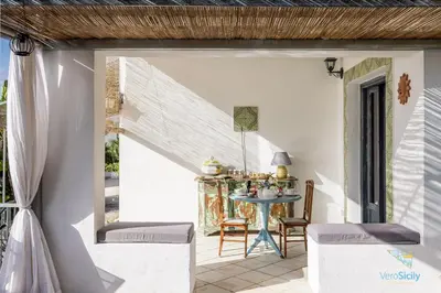 an outdoor patio with a table and chairs at Verosicily Panoramic House with access to the sea in Terrasini