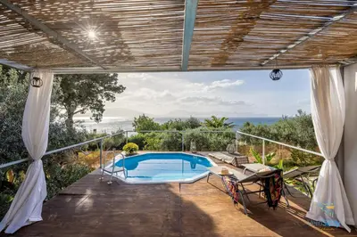 an outdoor patio with a swimming pool on top of a house at Verosicily Panoramic House with access to the sea in Terrasini