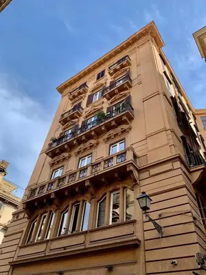 a tall building with balconies on the side of it at Vissi d'Arte Rooms in Palermo