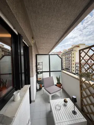 a balcony with a chair and a table on a building at La Casa di Trudy in Palermo