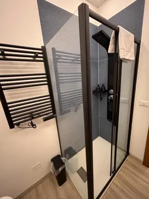 a shower with a glass door in a bathroom at La Casa di Trudy in Palermo