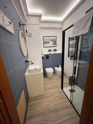a bathroom with a sink and a toilet at La Casa di Trudy in Palermo