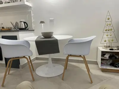 a kitchen with a table and two chairs and a christmas tree at la fervoriana in Palermo