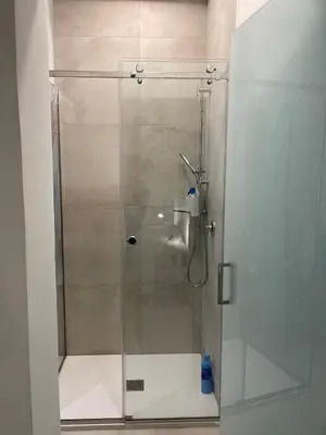 a shower with a glass door in a bathroom at la fervoriana in Palermo