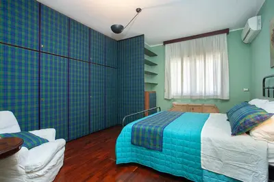 a bedroom with a bed and a couch in it at Casa Adele in Palermo