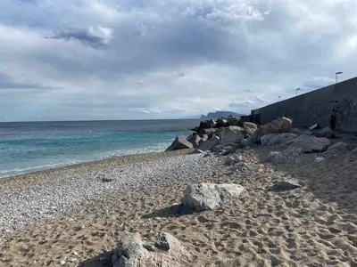 a rocky beach with rocks and the ocean at Una Finestra sul Mare in Palermo