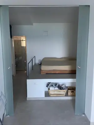 a small bedroom with a bed and a hallway at Una Finestra sul Mare in Palermo