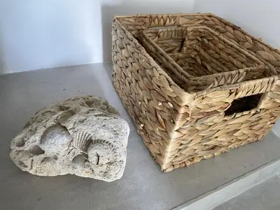a basket sitting on a table next to a rock at Una Finestra sul Mare in Palermo